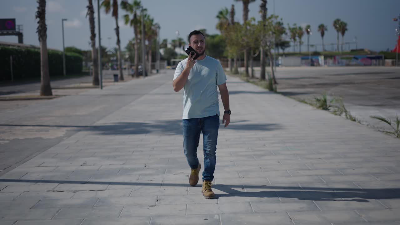 Man Walking and Talking on a City Path