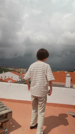 boy on a rooftop looking at the view