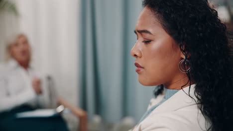 a woman listens intently to her therapist during a therapy session.