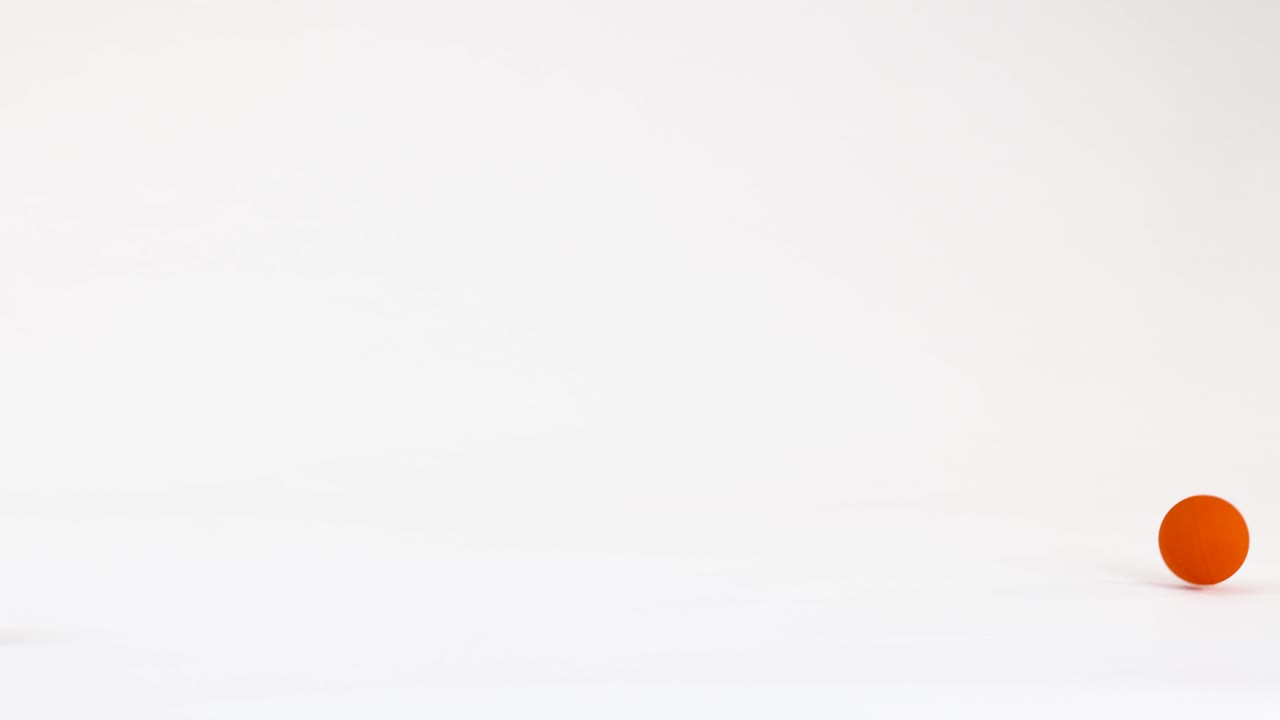 A minimalist animation of a bright orange sphere bouncing and rolling on a white surface