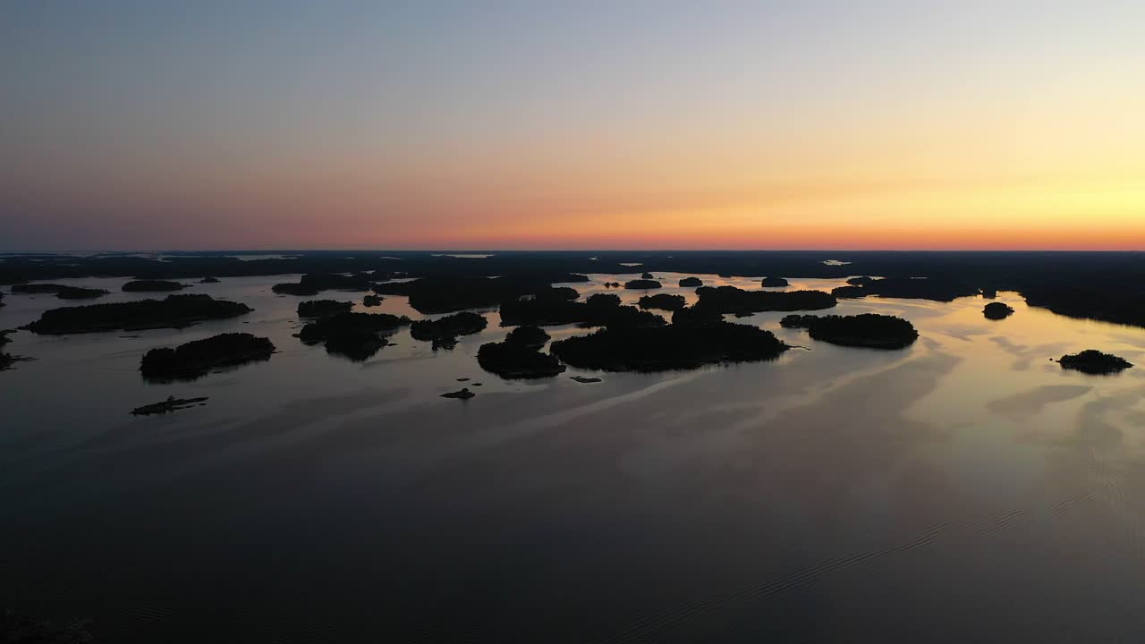 Aerial view overlooking small islands, on a serene, summer evening, in the Finnish archipelago, at the Gulf of Finland, in Tammisaari national park, Uusimaa- tracking drone shot