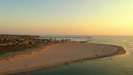drone circles around dog beach in ocean beach, san diego, california at sunset