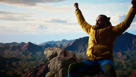 male mountain hiker celebrates a victorious climb and resting at the top