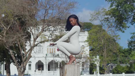 A-young-girl-in-a-white-bodysuit-delights-in-a-city-day-with-whitehall-castle-in-the-background