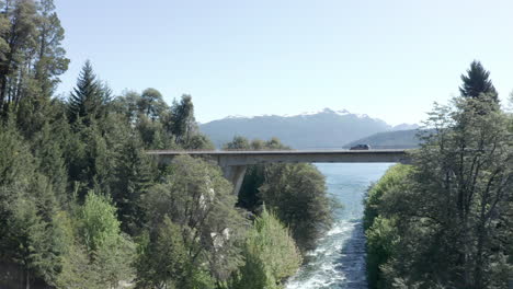 AERIAL---Bridge-over-Correntoso-River,-Neuquen,-Argentina,-forward-ascending