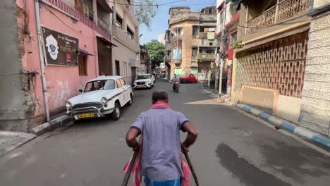 hand pulled rickshaw of kolkata passing by through south kolkata streets.