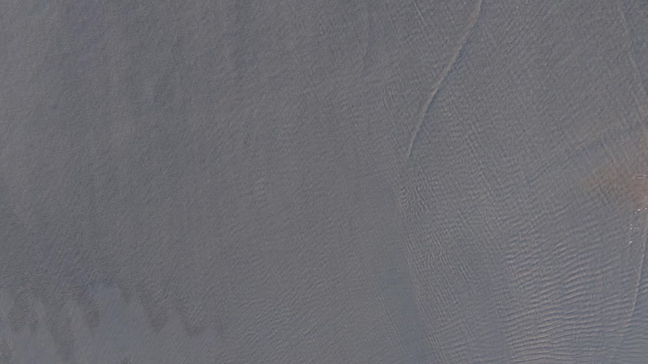 Above View Of A Man Running Across The Sandy Seacoast. Aerial Topdown Shot