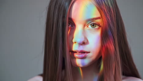 portrait of a woman with rainbow light on her face