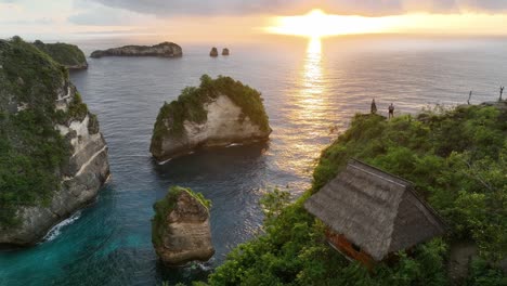 sunrise on a beautiful coastline with a tree house on a hill