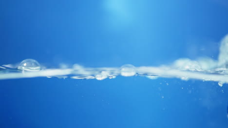 elegant slow-motion portrayal of blue water waves, highlighting the pure essence of drinking water and its refreshing qualities.