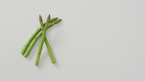 video of fresh asparagus with copy space over white background