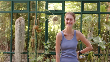 smiling woman in glass house, wearing sportswear, ready for yoga session, copy space