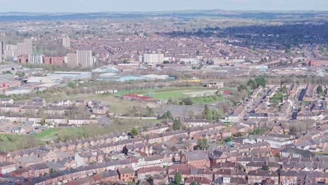 a top-view on densely designed districts of leicester: private homes, cottages, offices, and a stadium are seen on the city panorama