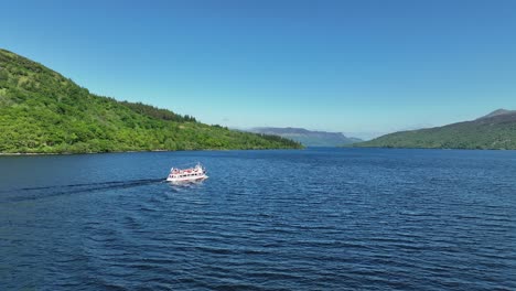 Aerial-Footage-of-Boat-Cruise-on-Loch-Katrine-in-The-Trossachs-Area-of-the-Scottish-Highlands,-Scotland-on-Hot-Summers-Day