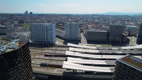 Aerial-drone-view-of-Vienna-train-station-from-above-on-a-sunny-day,-Austria-transport