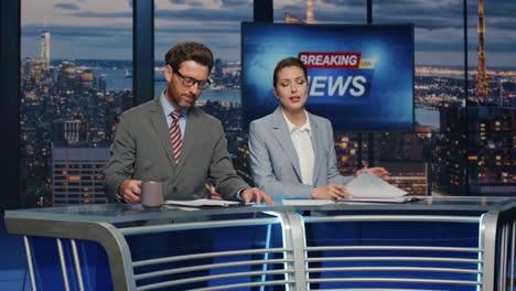 confident anchors announcing news at evening modern studio closeup. hosts talk