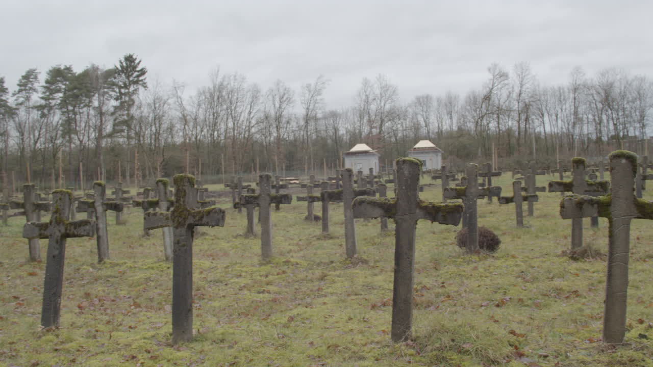 Wide pan of old gravestones at abandoned graveyard