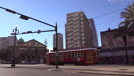 a red new orleans streetcar travels through the downtown area 1