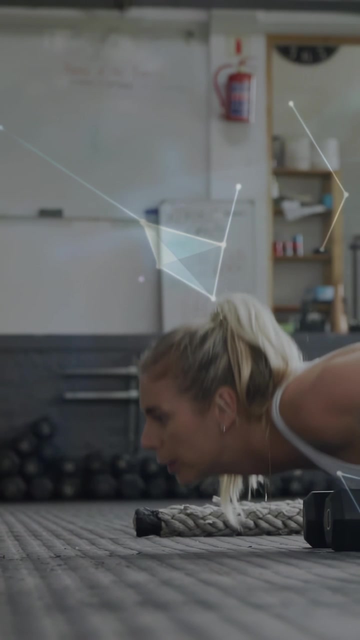 Vertical video: Female lowering into push-up on gym mat, overlays forming over rope, male entering