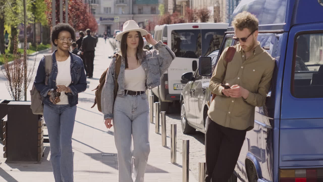 대담한 어린 소년이 여행을 떠나기 전에 자신의 밴 옆에서 두 소녀를 맞이합니다 1