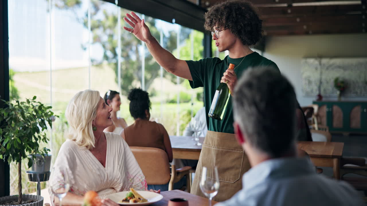 Waiter Presenting Wine Bottle to Couple at Upscale Restaurant