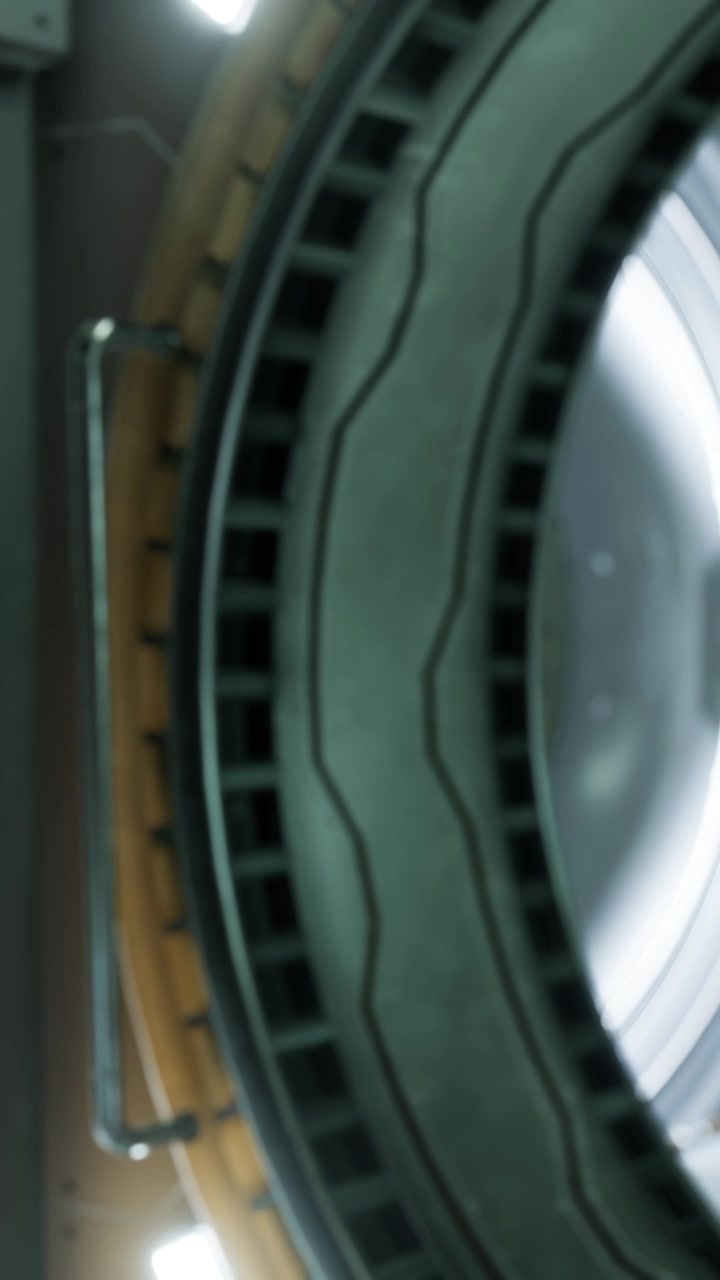 A large circular structure is shown up close in a futuristic environment