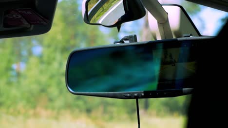 view from inside the car to the rear view mirror while other car is overtaking