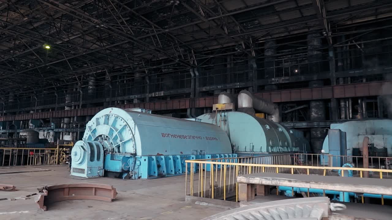 Turbine hall of a coal-fired thermal power plant. Engine room for generating electricity. Smoke from chimneys, metal structures in a factory