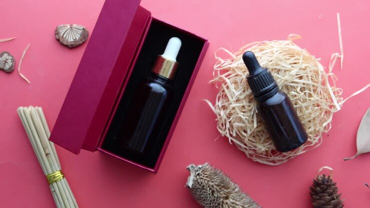 Eucalyptus essential oils in a glass bottle and herbs on red background ,
