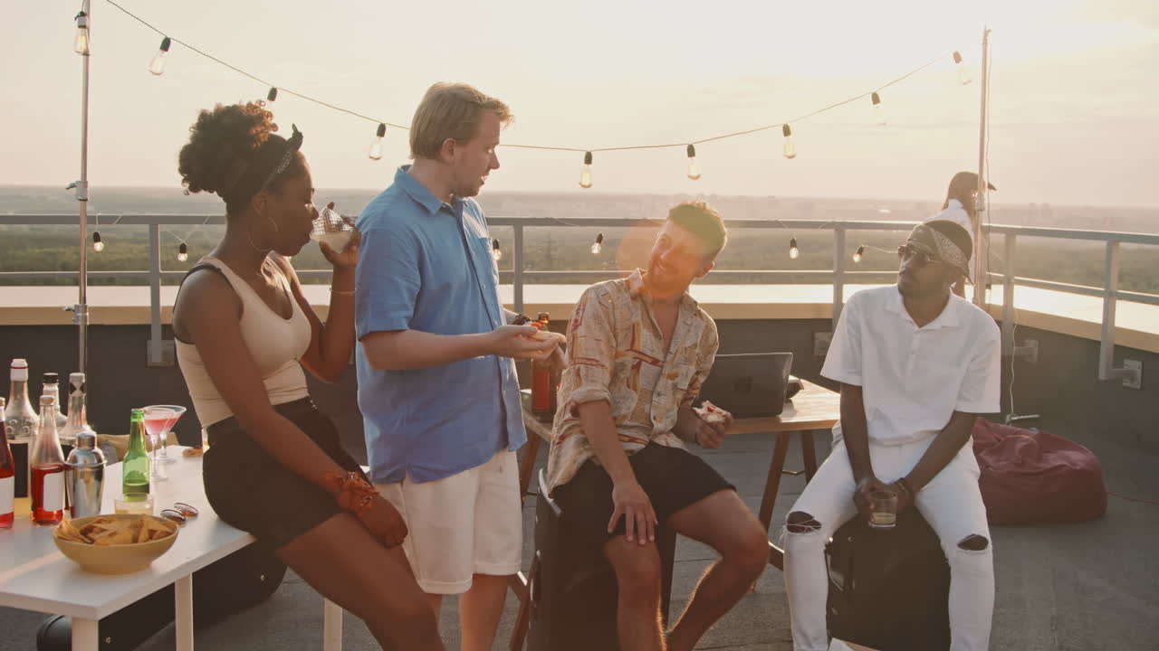 Young People Chatting on Rooftop Terrace on Summer Evening