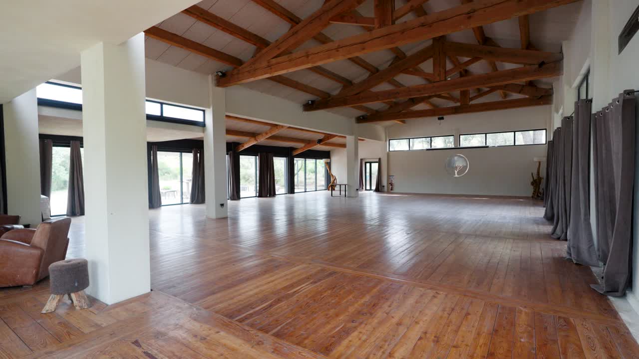 Slow establishing shot of a open plan studio within a villa