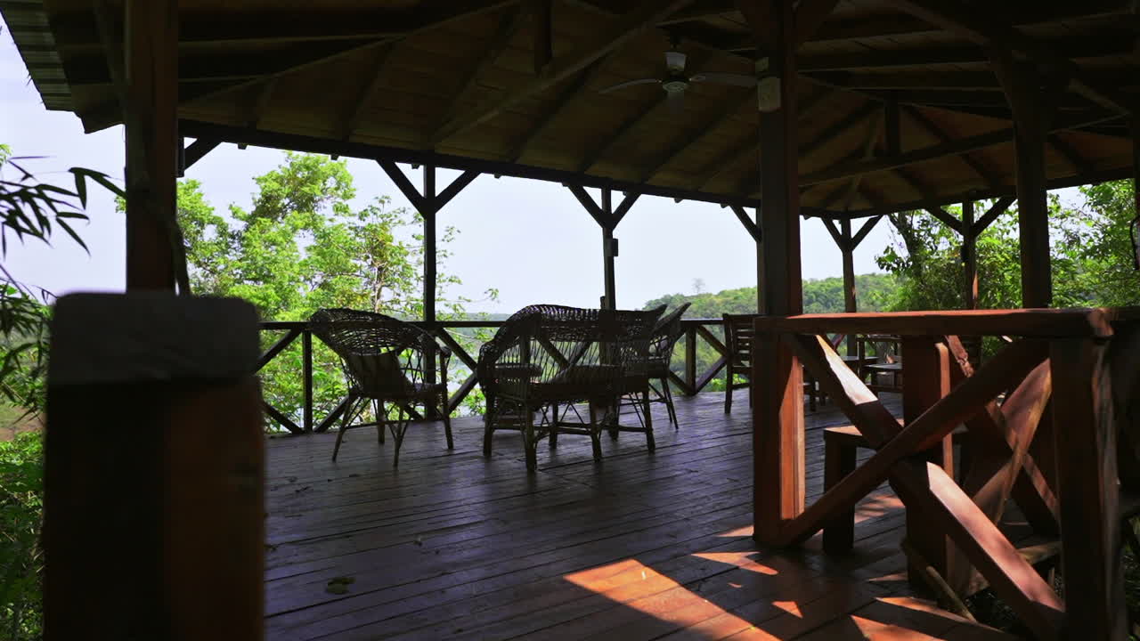 Wooden terrace with wicker chairs overlooking jungle, Puerto Iguazu Argentina, eco tourism and relaxation