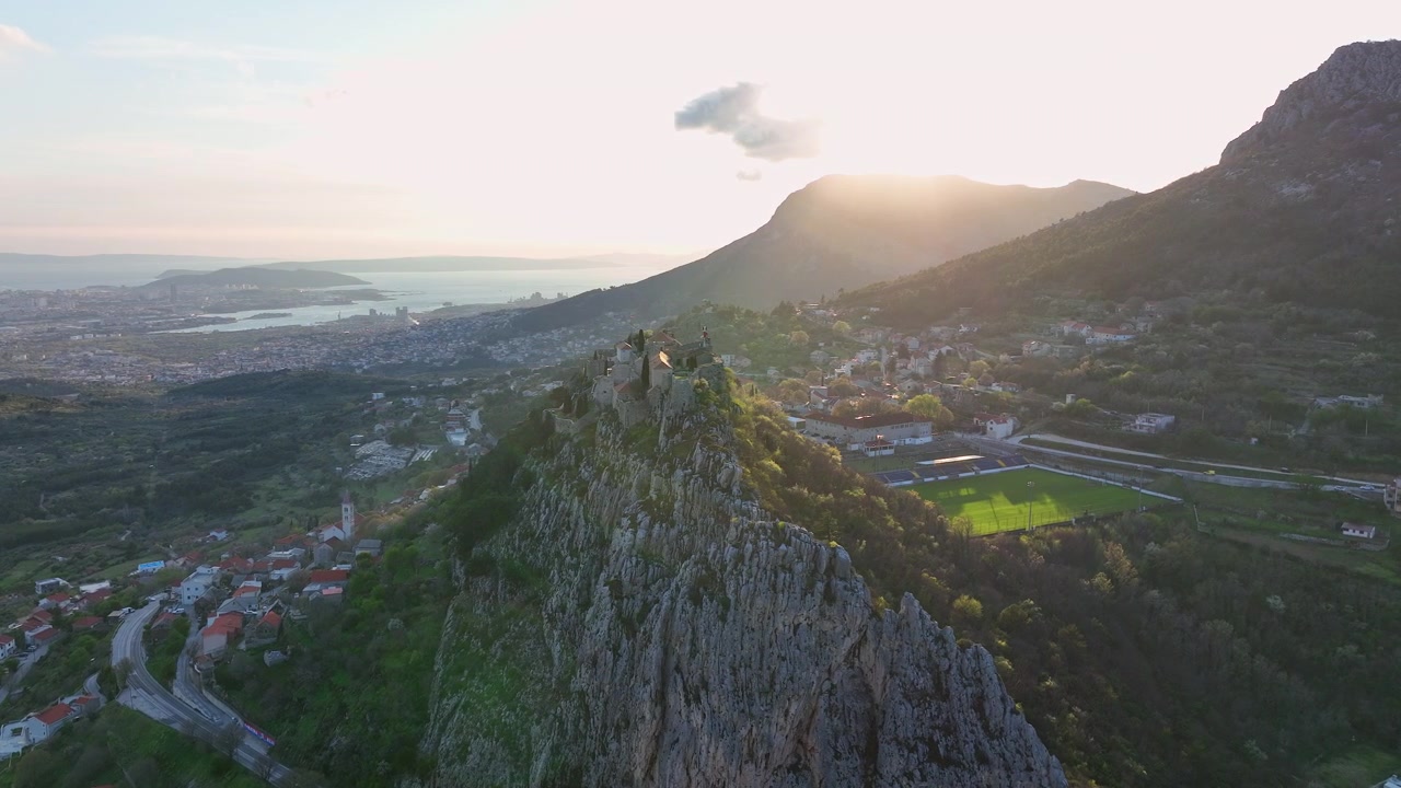 Drohnen-Luftaufnahme einer befestigten historischen Stadt auf einer steilen, zerklüfteten Klippe.