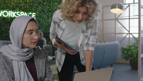 Mujer-De-Negocios-Reuniéndose-Con-Un-Colega-Intercambiando-Ideas-Trabajando-Juntos-Usando-Una-Computadora-Portátil-Líder-Del-Equipo-Compartiendo-Apoyo-Creativo-Disfrutando-De-La-Conexión-De-Trabajo-En-Equipo-En-Un-Espacio-De-Trabajo-De-Oficina-Moderno