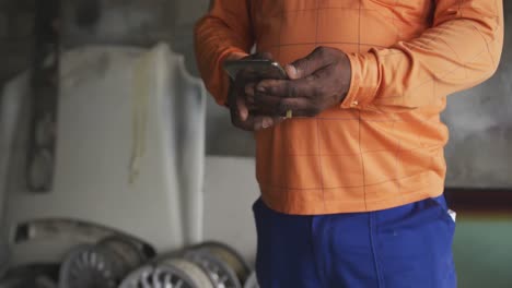 african man using phone at work