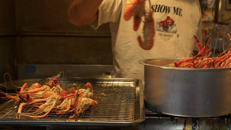 shrimp being prepared, cooked and fried in night bazaar of hat yai, thailand