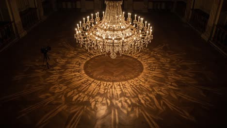 a majestic crystal chandelier casting intricate shadows on the floor in an elegant room, showcasing the beauty of light and reflection
