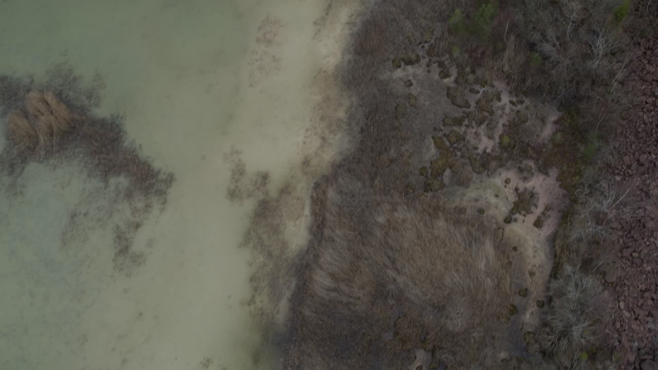 Aerial view drone flight winter landscape over rocks and lake in Kinnekulle Sweden