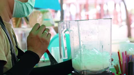 making a smoothie at a street food stall