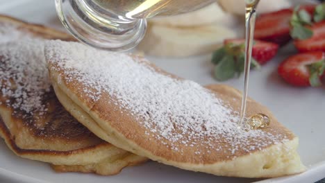 delicious pancakes with honey and strawberries