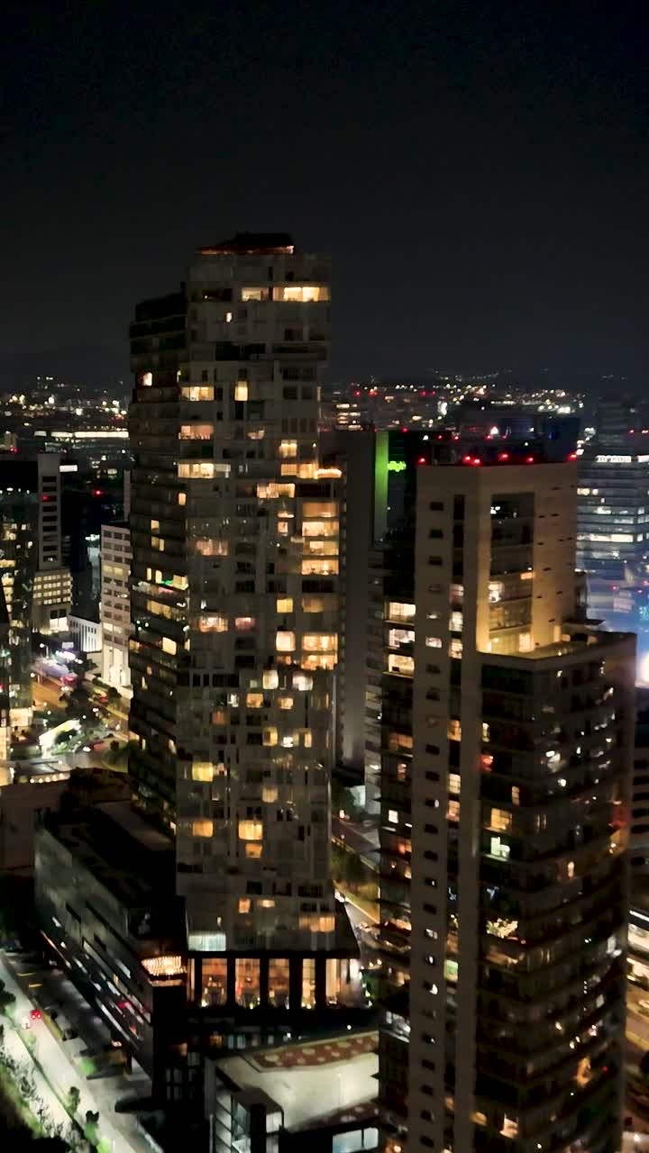 Vertical aerial view of the night architecture of Santa Fe in Mexico City