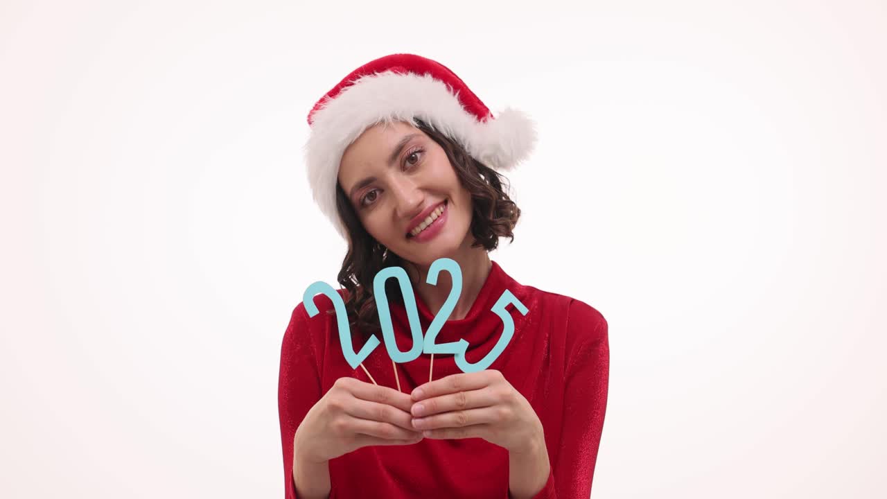 Happy Woman in Santa Hat Holding 2025 Sign for New Year Celebration