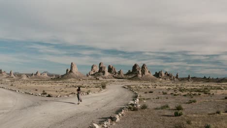 Unique desert landscape, a woman is walking into the frame