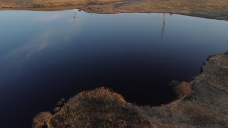 tilt up reveal of windmills during golden hour, scotland