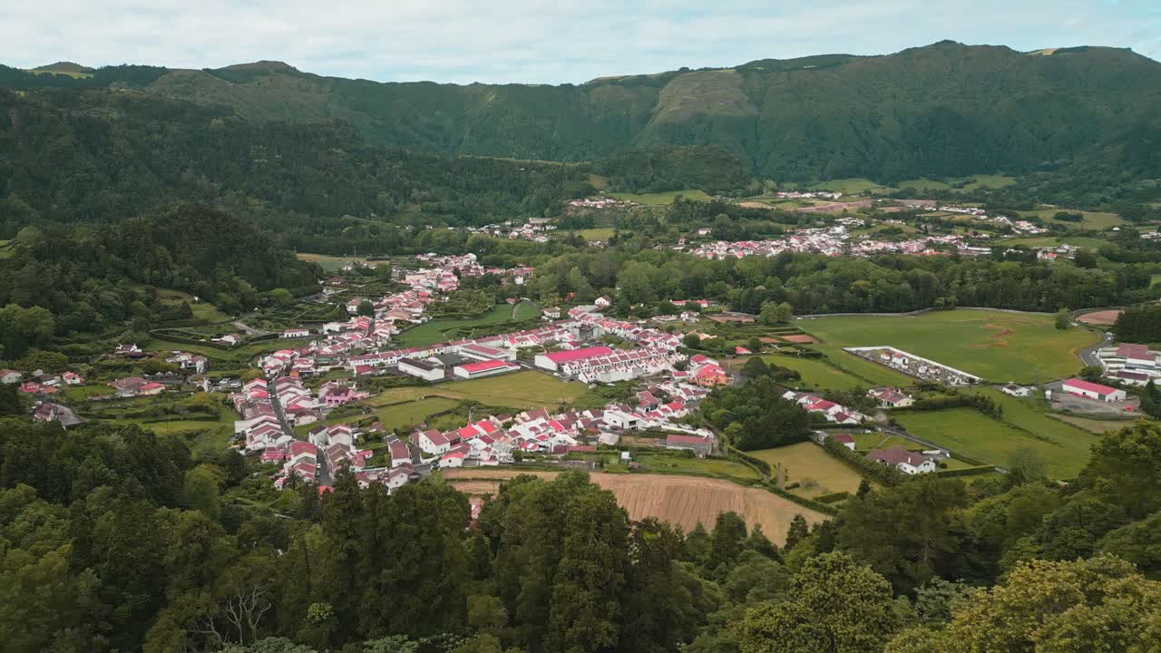 Aerial view of a picturesque village nestled in a green valley