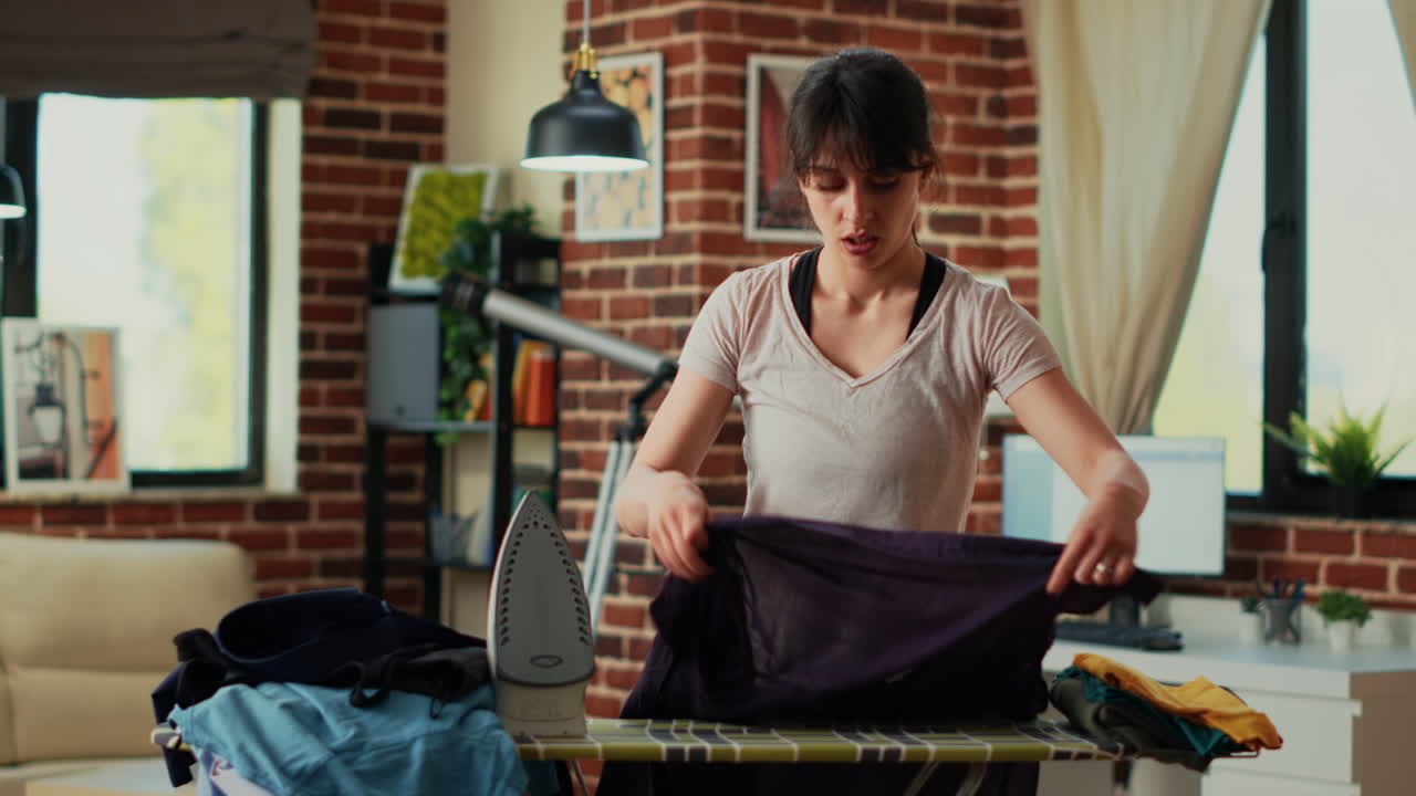 Unhappy person feeling exhausted of ironing laundered clothing