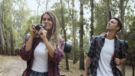 happy hikers with photo camera taking pictures of landscape