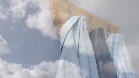 Animation-of-clouds-and-blue-sky-over-hanging-clothes