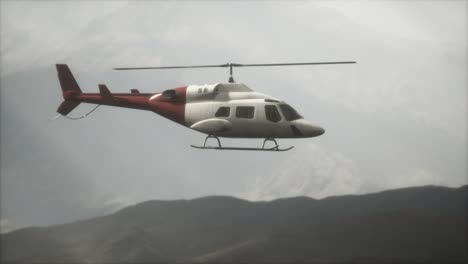 helicóptero volando en cámara lenta extrema cerca de las montañas con niebla