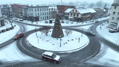 american town center decorated with christmas tree during winter snow storm